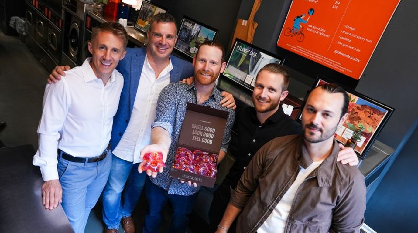 Robert and the Laundry Sauce team holding an open box of detergent pods