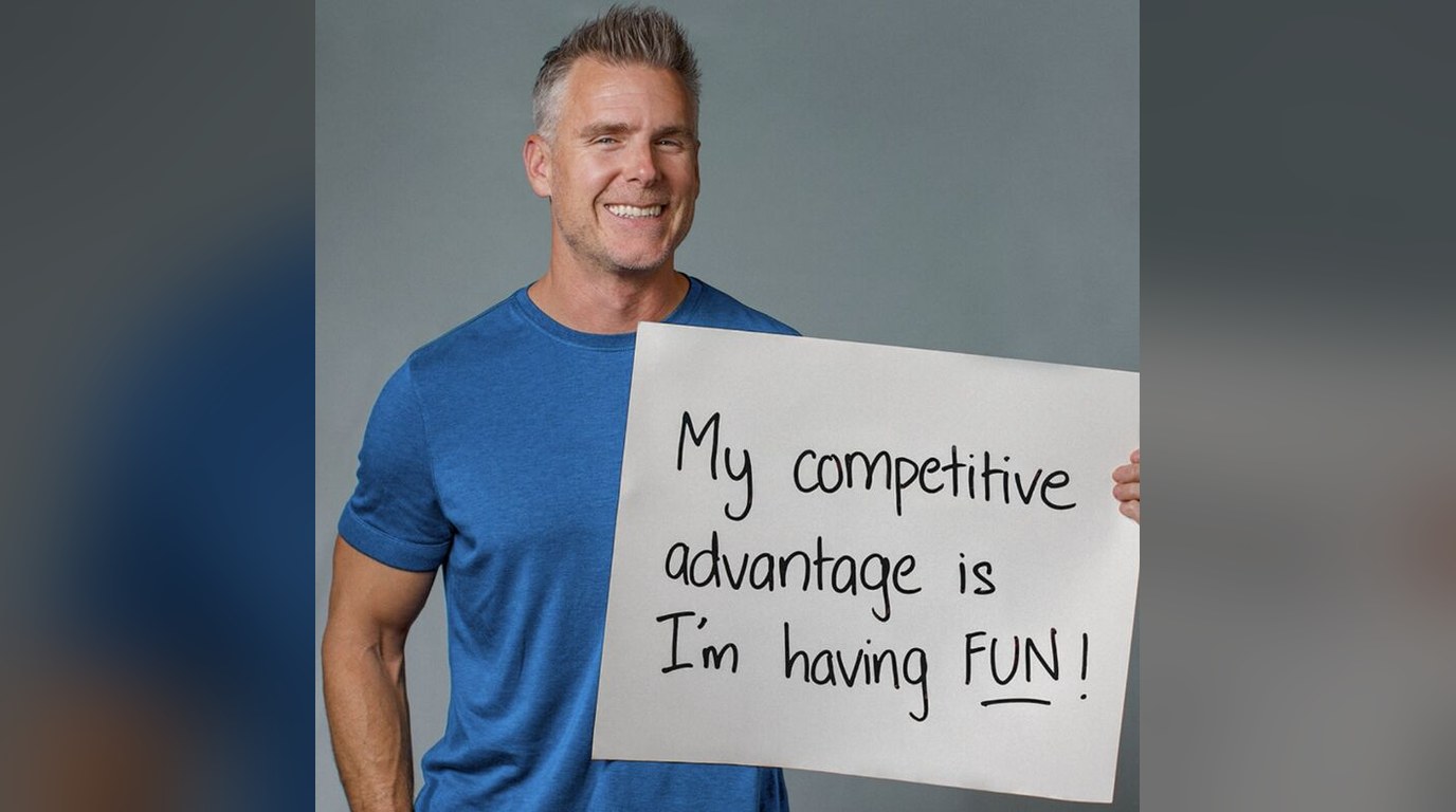 Dan Martell holding a sign: "My competitive advantage is I'm having fun!"