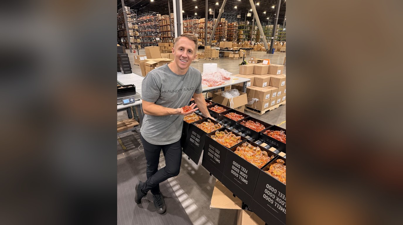 Robert in the warehouse next to bins of Laundry Sauce boxes